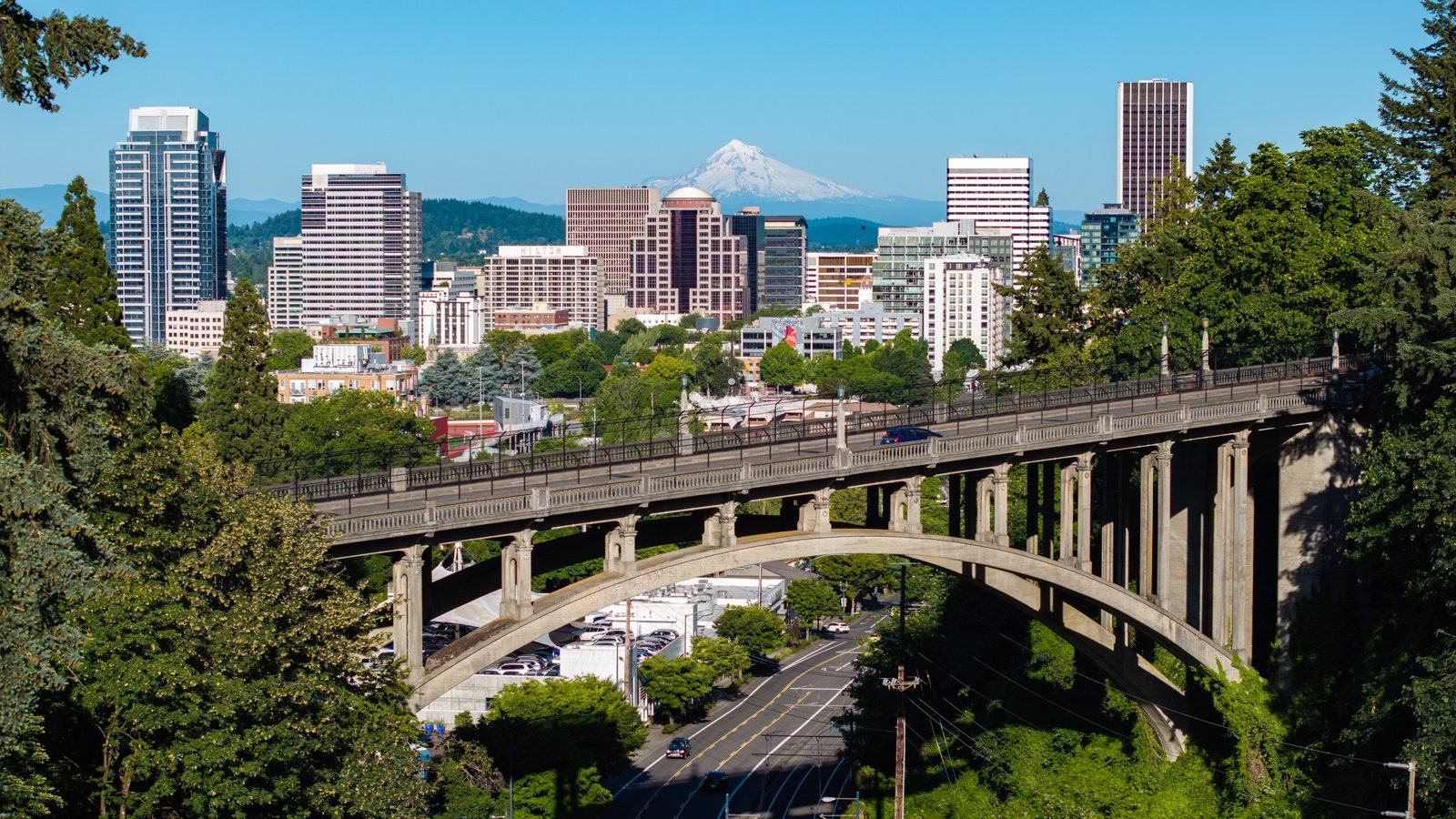 Downtown Portland, Oregon skyline with Mount Hood behind it and Vista Bridge in the foreground