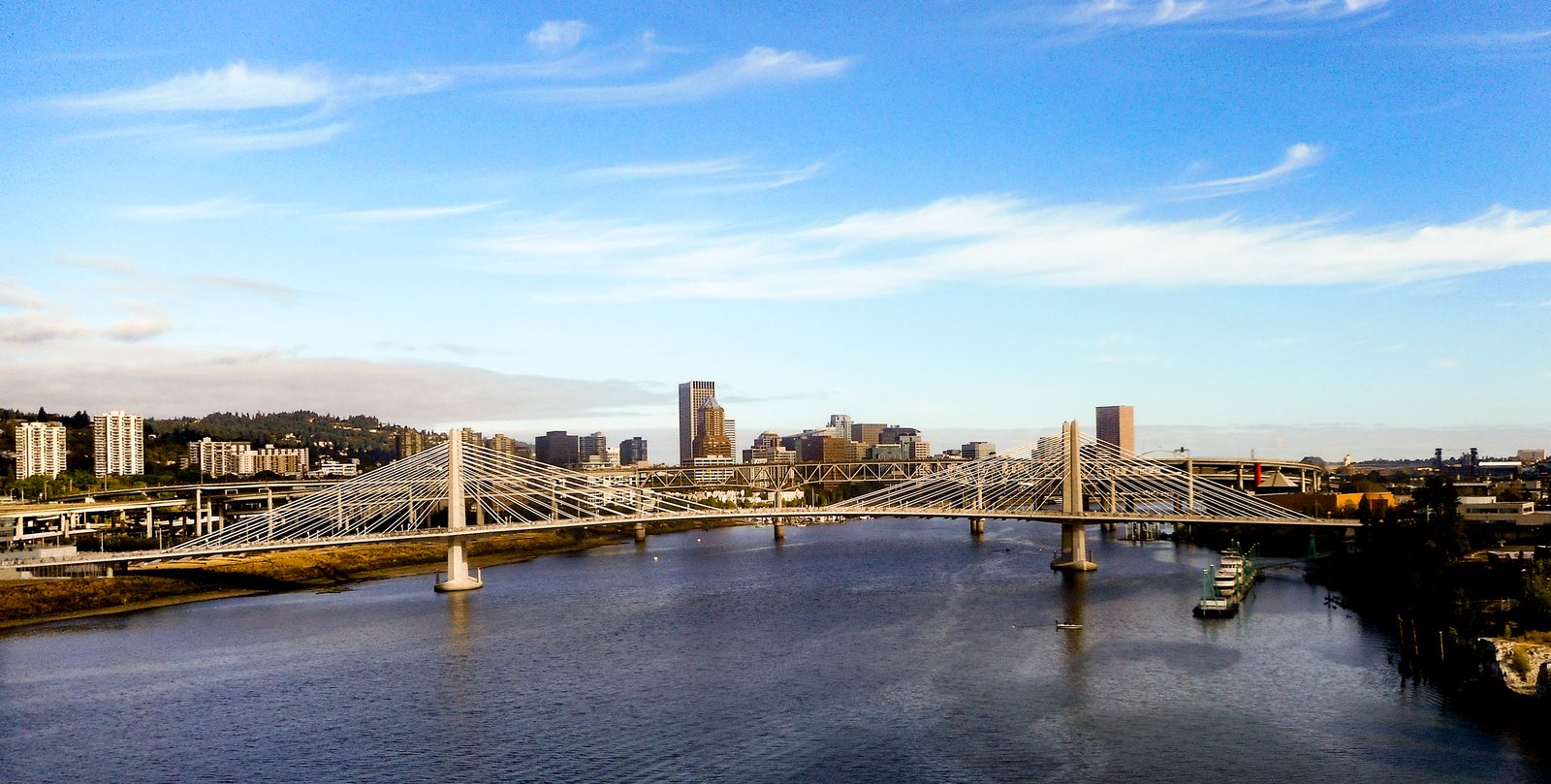 Tilikum Crossing over the Willamette River, with the downtown skyline behind it